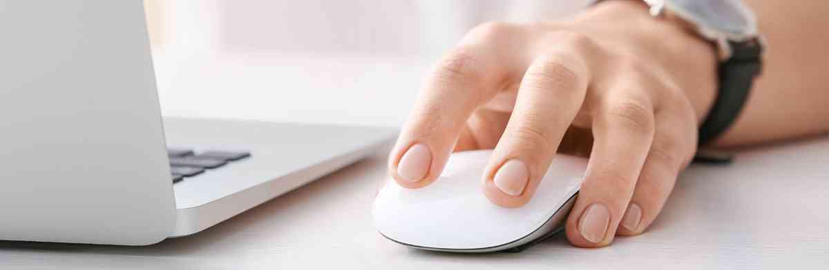 Man clicking on an Apple mouse.